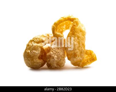 Pork snack crispy and blistered isolated on white background. Crispy pork skin pieces. Food concept. Stock Photo