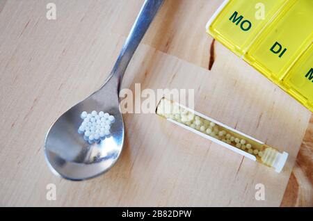 Globuli pills and box with indication of the weekday name Stock Photo