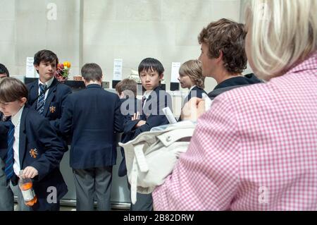Lots of school children, school boys at the British museum, on a school trip getting snacks. Stock Photo