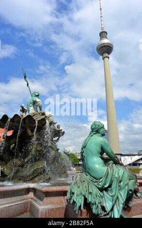 Berlin, Germany 05-17-2019 Neptune Fountain and TV Tower in the City center Stock Photo