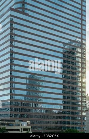 view on steel and glass office skyscraper building which reflect other buildings around it. Miami, Florida, United States of America. Stock Photo