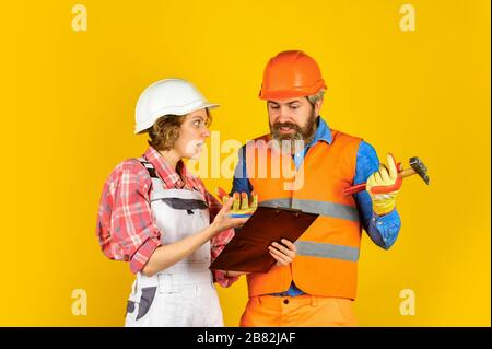 confident electrical and technician. engineers couple working together on building blueprint. work at construction site or factory. Civil engineering. industrial business partner. job and occupation. Stock Photo