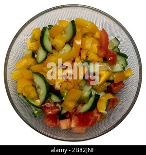 Healthy food . Ready to eat vegetable salad in glass bowl. Sliced tomato, cucumber, paprika, green onion, dill and parsley Stock Photo