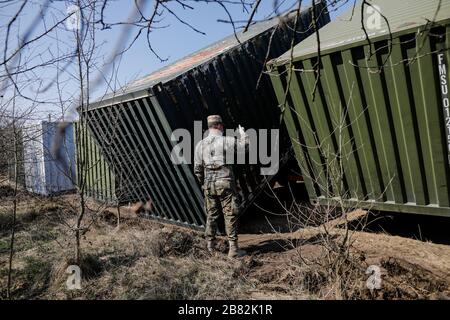 Otopeni, Romania - February 19, 2020: Personnel of the Romanian Army work on the installation of a campaign mobile hospital (ROL 2) to treat Covid-19 Stock Photo