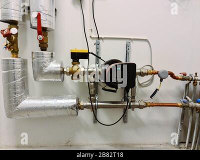 Water system in an industrial building electric water pump and pipes. Building interior  design elements concept. Stock Photo