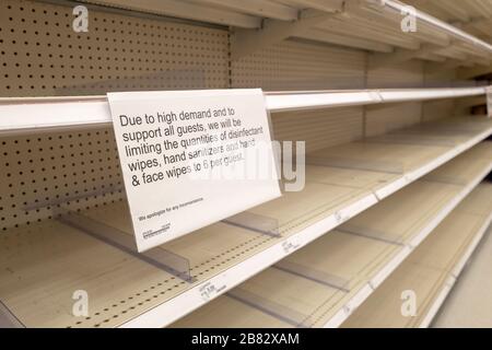 Empty shelves and a sign regarding product rationing are visible at a Target retail store in Contra Costa County, San Ramon, California, as residents purchase all available stock of toilet paper, paper towels, canned goods, hand sanitizer and other essential items during an outbreak of the COVID-19 coronavirus, March 12, 2020. ()