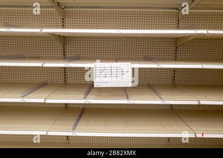 Empty shelves and a sign regarding product rationing are visible at a Target retail store in Contra Costa County, San Ramon, California, as residents purchase all available stock of toilet paper, paper towels, canned goods, hand sanitizer and other essential items during an outbreak of the COVID-19 coronavirus, March 12, 2020. ()