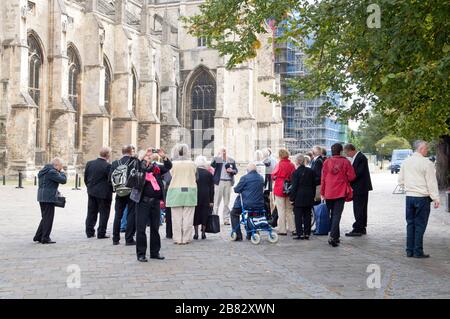 People, tourists, in the grounds of Canterbury Cathedral, Canterbury, Kent, England Stock Photo