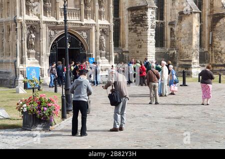 People, tourists, in the grounds of Canterbury Cathedral, Canterbury, Kent, England Stock Photo