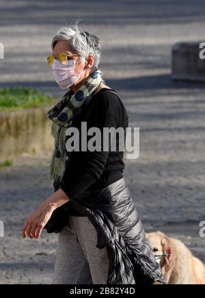Milan, Italy. 19th Mar, 2020. Milan, CORONAVIRUS - People around the city. Pictured: People walking the dog Credit: Independent Photo Agency/Alamy Live News Stock Photo