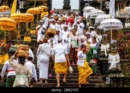 Balinese Hindu People At The Batara Turun Kabeh Ceremony, Besakih Temple, Bali, Indonesia. Stock Photo