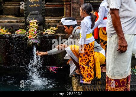 Balinese People Visiting The Tirta Empul Water Temple During A Festival, Bali, Indonesia. Stock Photo