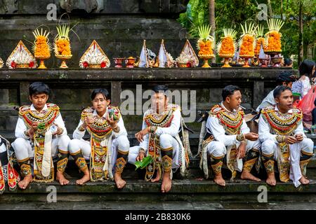 A Group Of Young Men In Costume Attending A Hindu Festival, Tirta Empul Water Temple, Bali, Indonesia. Stock Photo