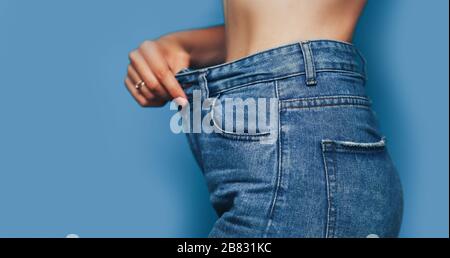 skinny woman body with Loose pants jeans, Light weight body with loose clothes, slender and Healthy body low fat concept Stock Photo
