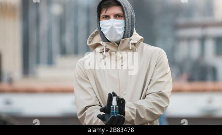 Close-up of young person holding in the hand antiseptic or anti bacteria spray. Disinfecting hands. Concept of health care during an epidemic or pande Stock Photo