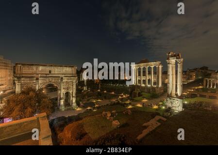 Roman Forum ruins with the Arch of Severus, temple of Saturn, temple of Vesta, Basilica of Maxentius, Arch of Titus and Colosseum in Rome, Italy, seen Stock Photo