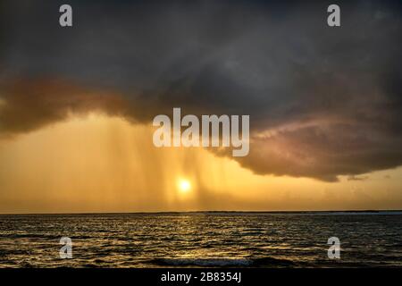 Stormy clouds with rain falling out over the Caribbean Sea Stock Photo