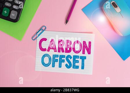 Writing note showing Carbon Offset. Business concept for Reduction in emissions of carbon dioxide or other gases Electronic mouse calculator paper she Stock Photo