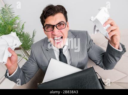 The angry businessman with crumbled paper Stock Photo