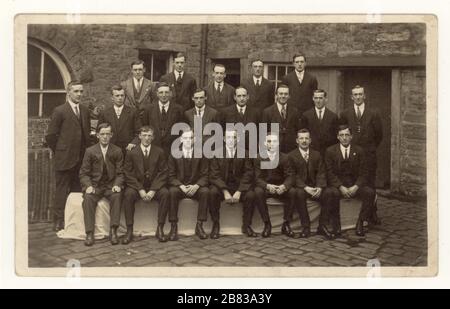 Original early 1900's postcard of group of gentlemen mill office workers wearing smart suits pose for a group photograph outside, Perseverance Mill, (Albion Mill)  Padiham, Burnley, Lancashire, England, U.K. 1919