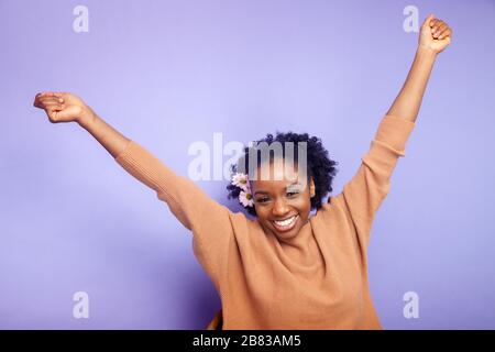 Young woman with arms outstretched in carefree moment Stock Photo