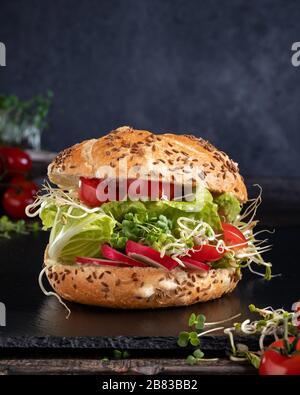 Veggie burger with fresh radish and fenugreek sprouts and broccoli microgreens Stock Photo