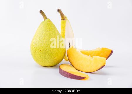 Tasty fruit snack - Fresh and sweet pears with flat peach - Pear slices and flat peach slices Stock Photo