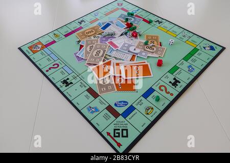 Orlando, FL/USA-12/20/19:  Pieces for the game Monopoly by Hasbro on a white background.  Concept business, finance, banking, real estate, and propert Stock Photo