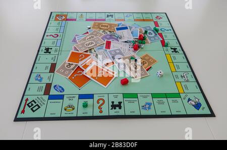 Orlando, FL/USA-12/20/19:  Pieces for the game Monopoly by Hasbro on a white background.  Concept business, finance, banking, real estate, and propert Stock Photo