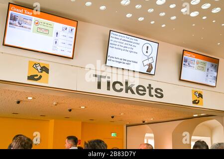 VIENNA, AUSTRIA - NOVEMBER 2019: Ticket office of the Schonbrunn Palace in Vienna with people queuing for tickets and electronic information display