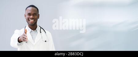 Portrait Of Happy Confident Doctor Offering Handshake In Hospital Corridor Stock Photo