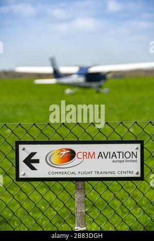 WHITE WALTHAM, ENGLAND - MARCH 2019: CRM Aviation Europe Limited sign on a fence at White Waltham airfield. Stock Photo