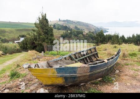 Lake Tota, Boyaca / Colombia: April 7, 2018: Old broken boat on the shore of the largest Colombian lake
