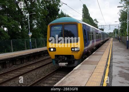 Northern Trains Class 323 electric multiple-unit, suburban train, entering railway station at Bramhall, Stockport, Cheshire, near Manchester, England Stock Photo