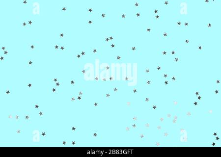 Falling confetti background. Sparkles on pastel blue trendy background. Festive backdrop for your projects. Stock Photo