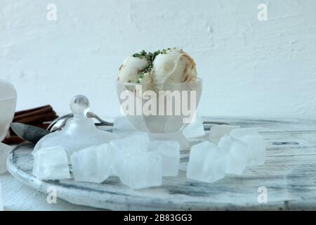 Homemade Organic white Vanilla Ice Cream with Nuts and ice cubes and big cinamonas Stock Photo