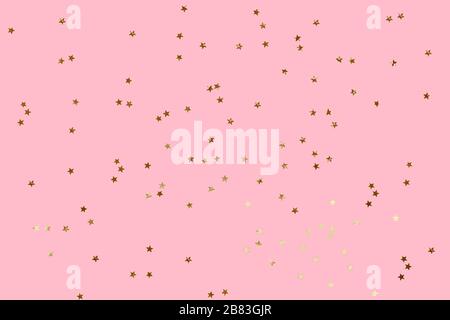 Falling confetti background. Sparkles on pink pastel trendy background. Festive backdrop for your projects. Stock Photo