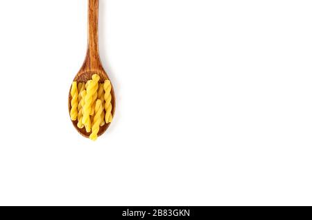 Raw Italian pasta in wooden spoon on white background. Food and drink concept. Top view. Copy Space Stock Photo
