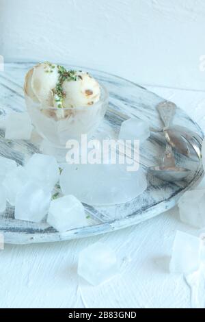 Homemade Organic white Vanilla Ice Cream with Nuts and ice cubes and big cinamonas Stock Photo