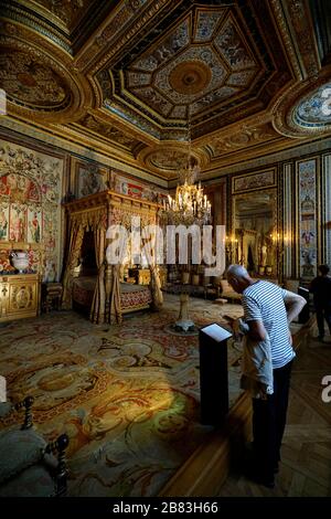 A visitor inside of the bedroom of Anne of Austria, the wife of King Louis XIII in the Pope's Apartment.Palace of Fontainebleau.Seine-et-Marne.France Stock Photo
