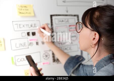 Women website designer creative planning application development drawing template layout framework wireframe design studio . User experience concept Stock Photo
