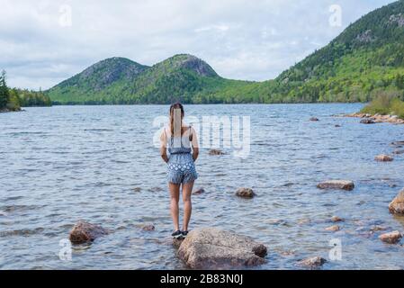 Woman enjoying the beautiful view of Jordan Pond in Acadia National Park Maine USA Stock Photo