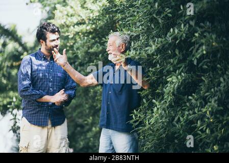 Hipster son with his senior father at home. Stock Photo