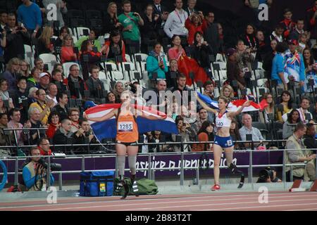 Women's 100m T44 Dutch silver medallist sprinter Marlou van Rhijn celebrating with gold medallist Marie-Amelie Le Fur in the background at the 2012 Su Stock Photo