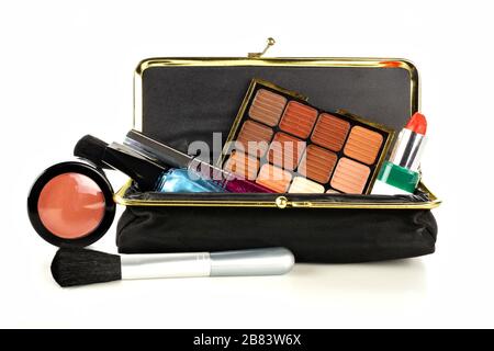 Makeup bag with assorted cosmetics isolated on a white background Stock Photo