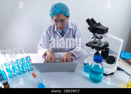 using laptop for working in laboratory Stock Photo