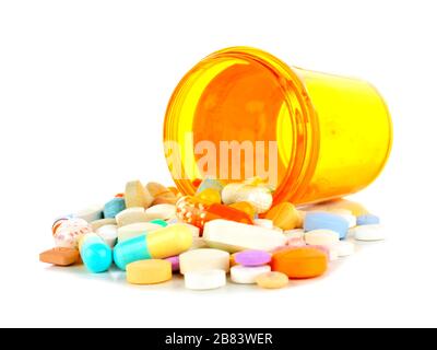 Pill bottle with spilling medications over white Stock Photo