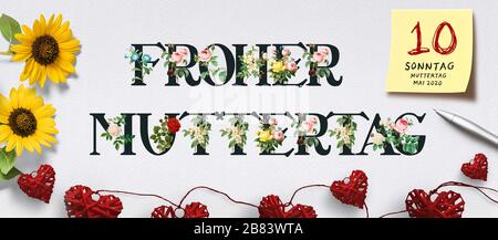 banner with German text HAPPY MOTHER'S DAY with flowers and heart-shaped decoration on paper background Stock Photo
