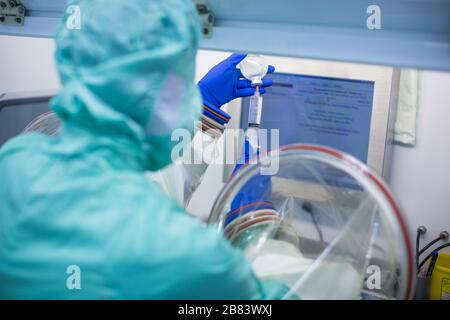 Virus antidote being prepared in a biochem lab with extremely strict precautionary measures (shallow DOF; color toned image) Stock Photo