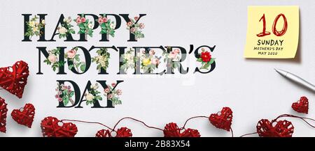 banner with text HAPPY MOTHER'S DAY with flowers and heart-shaped decoration on paper background Stock Photo